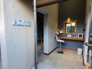 a house entrance with a home sign on a wall at Bendor Garden Flat in Polokwane