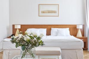 Postel nebo postele na pokoji v ubytování Hotel Palatin