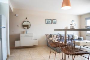 Vistas del Sur - Un dormitorio - LV في نيوكين: غرفة معيشة مع طاولة وكراسي