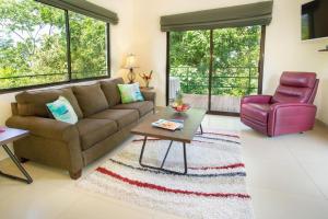 a living room with a couch and a chair at Villa Mariposa - Peaceful and relaxing with ocean view & WiFi in San Antonio