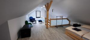 a room with a bed and a couch in a room at Apartmány Aktiv Lipno in Lipno nad Vltavou