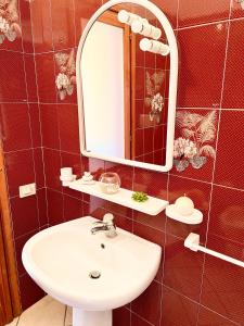 a bathroom with a sink and a mirror at Casa Greta in Costa Rei +19 photos