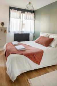 a bedroom with a large bed with two towels on it at Le Champollion - Clim - Gare - Garage - Balcon in Albi