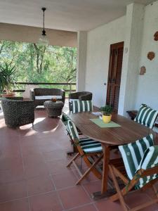 a wooden table and chairs on a patio at Valle degli Ulivi appartamento in Terni