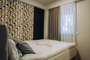Tempat tidur dalam kamar di Bellissimo Apartments