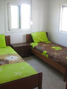 Un pat sau paturi într-o cameră la Вила Маламос