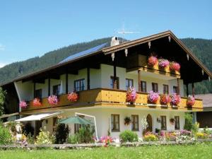 a large building with flowers on the balcony at Gästehaus Sterrhäusl - Chiemgau Karte in Inzell