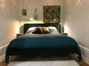 a bedroom with a large blue bed with a window at Artistic and light 2 room apartment in SoFo 65sqm in Stockholm