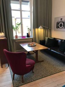 a living room with a couch and a coffee table at Bohemian and light one room apartment in SoFo 31sqm in Stockholm