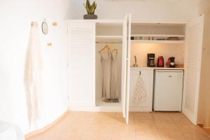 a kitchen with a door open to a pantry at Athiri by A Terre Cave Villas in Oia