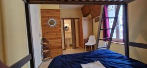 a view of a bedroom with a bed and a mirror at "Le 5" RÉSIDENCE BROUSSE in Le Mont-Dore