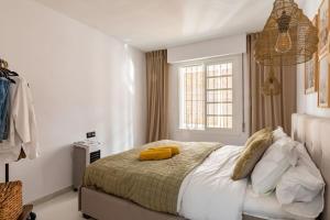 A bed or beds in a room at Eco Playa Suites - Beach & Golf!