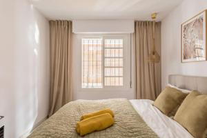 A bed or beds in a room at Eco Playa Suites - Beach & Golf!