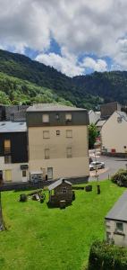 a building with a small house in a yard at "Le 5" RÉSIDENCE BROUSSE in Le Mont-Dore