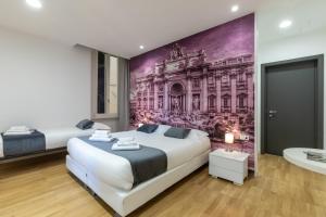 a bedroom with two beds and a painting on the wall at Trevi Elite Rome in Rome