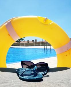 a pair of glasses sitting next to a pool at Ocean Romance (Duplex) in Puerto de Santiago