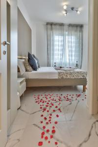 a bedroom with a bed with red petals on the floor at Sofia Holiday in Riomaggiore