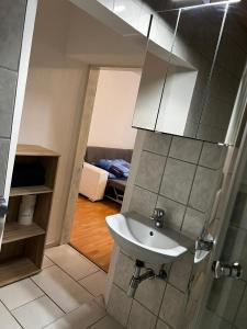 a bathroom with a sink and a mirror at FeWo Teusch Top4 in Arnoldstein