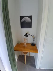 a wooden table topped with a lamp next to a wall at Airlie Beach Eco Cabins - Adults Only in Cannonvale