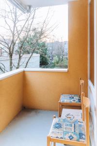 a room with two chairs and a table and a window at Messe Apartments in the center of basel in Basel