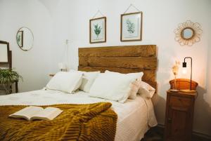 a bedroom with a bed with two books on it at CASA RURAL LA LIBERTAD in Monesterio