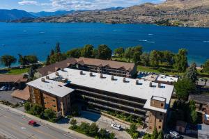an aerial view of a building next to a lake at Luxury Lake View Condo, Heated Pool, Hot Tub, and BBQ in Chelan