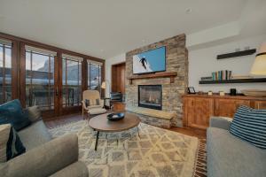 a living room with a couch and a fireplace at Ballard 203 North - Luxury Condo w/ Postcard Views in Telluride