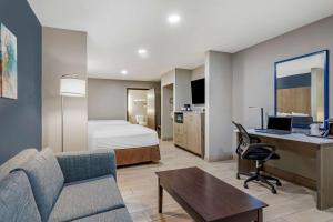 a hotel room with a bed and a desk at Best Western Plus Edinburg Inn & Suites in Edinburg