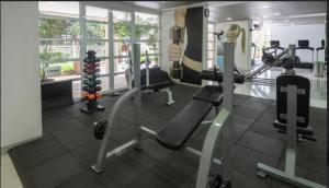 a gym with treadmills and machines in a room at Duplex Impression Morumbi in São Paulo