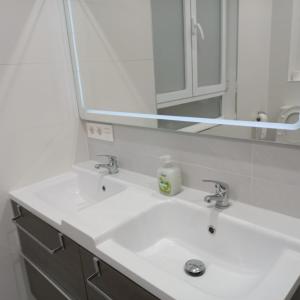 a bathroom with a white sink and a mirror at Magnifica swit room sama in San Sebastián