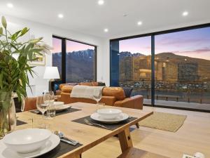 a living room with a table and a couch at Woods Villa Tui in Queenstown