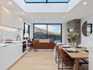 a kitchen and dining room with a table and chairs at Woods Villa Tui in Queenstown