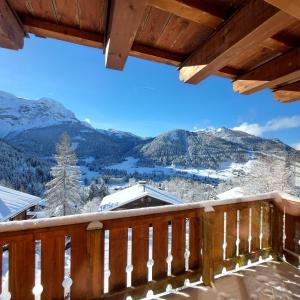 a view from a deck in the snow at Chambre d'hôtes L'ours Bleu in Les Diablerets