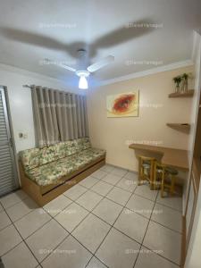 a living room with a couch and a table at DiRoma Fiori Caldas Novas - YMT - 030 in Caldas Novas