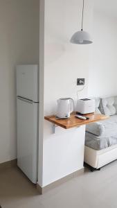 a kitchen with a white refrigerator and a table at Patagonia Apart Dpto 3 in Paraná