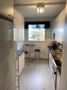 a small kitchen with a table and a window at M Apartments Tesomankuja in Tampere