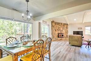 a dining room with a table and a fireplace at Cabin with Deck Located in The Sherwood Forest! in Twain Harte
