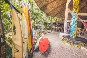 a group of surfboards are lined up on a patio at Pura Vida Hostel in Tamarindo