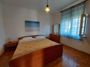 Postel nebo postele na pokoji v ubytování Apartments Fam Tomasic