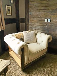 a white couch sitting in a room at The Threshing Barn at Penrhos Court in Kington