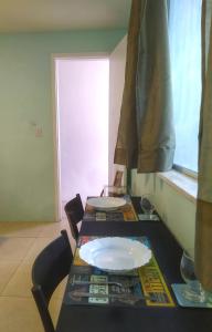 a table with a white plate on top of it at Studio 2 em Itapuã 900m da praia! in Salvador