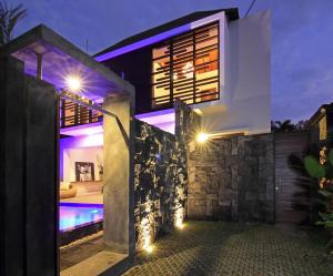 a villa with a swimming pool at night at Abivilla in Seminyak