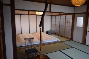 a room with a bed and a chair in it at Blue 200-1 / Vacation STAY 3808 in Utasutsu