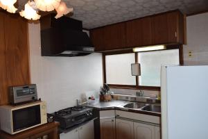 a small kitchen with a sink and a microwave at Blue 200-1 / Vacation STAY 3808 in Utasutsu