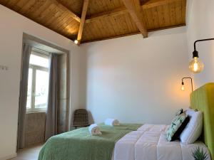 波多的住宿－Lost Inn Porto Hostel，一间卧室设有一张绿色的床和一个窗户。