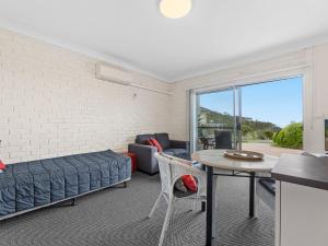 
a living room with a couch and a table at Golfers Lodge Unit 1 in Narooma
