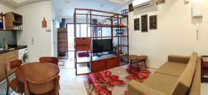 a living room with a couch and a table at Timurbay Seaview & Poolview by Zuhayr Suite in Kuantan