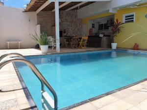 a large swimming pool with blue water in a house at atalaia mar I in Aracaju