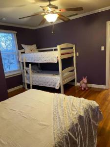 a bedroom with two bunk beds and a ceiling fan at Cornerhouse, an Abilene Classic in Abilene