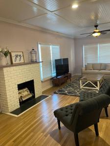 a living room with a couch and a fireplace at Cornerhouse, an Abilene Classic in Abilene